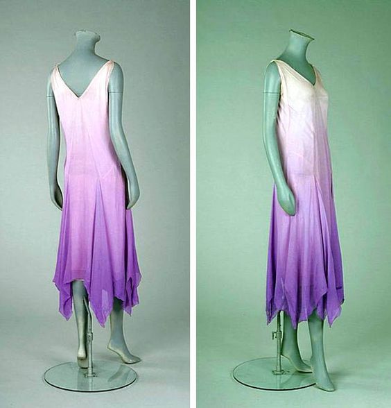 Madeleine Vionnet lilac ombré chiffon bias-cut cocktail gown, ca. 1927. Simple slip-like gown with slightly ruched bodice to either side of the central inset point. Skirt falls in gored handkerchief pleats, the V-neckline and armholes edged with simple silver picot thread, integral petticoat.